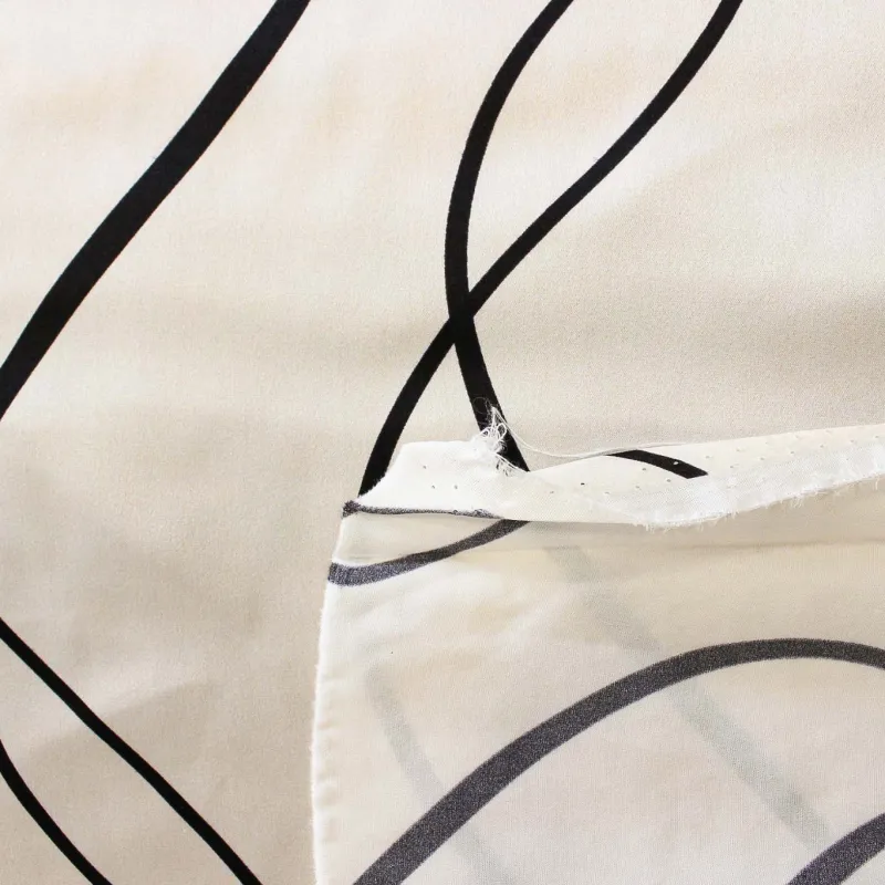 Raso con stampa astratta bianco nero | IL TESSUTAIO