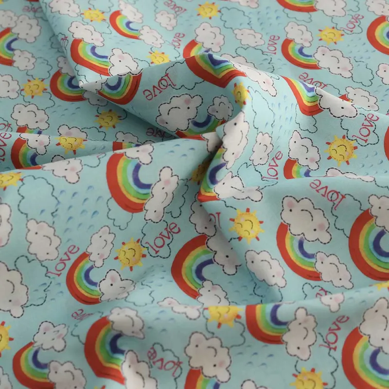 TESSUTO DI COTONE FANTASIA NUVOLE E ARCOBALENI | ILTESSUTAIO.IT