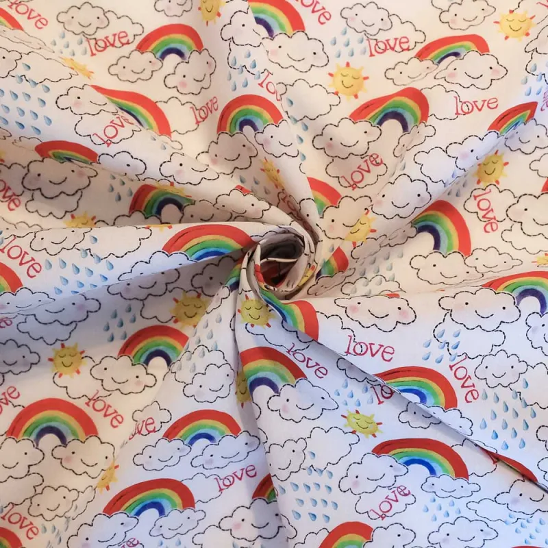TESSUTO DI COTONE FANTASIA NUVOLE E ARCOBALENI | ILTESSUTAIO.IT