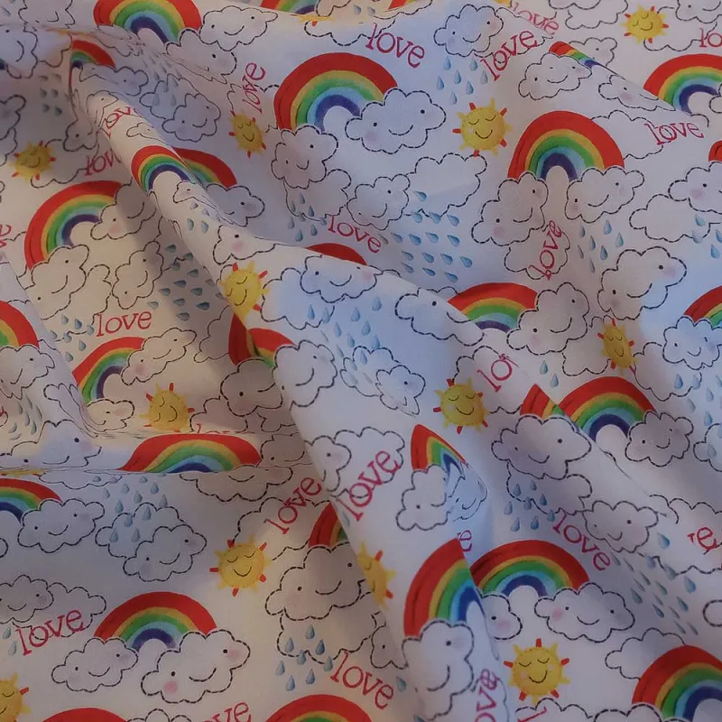 TESSUTO DI COTONE FANTASIA NUVOLE E ARCOBALENI | ILTESSUTAIO.IT